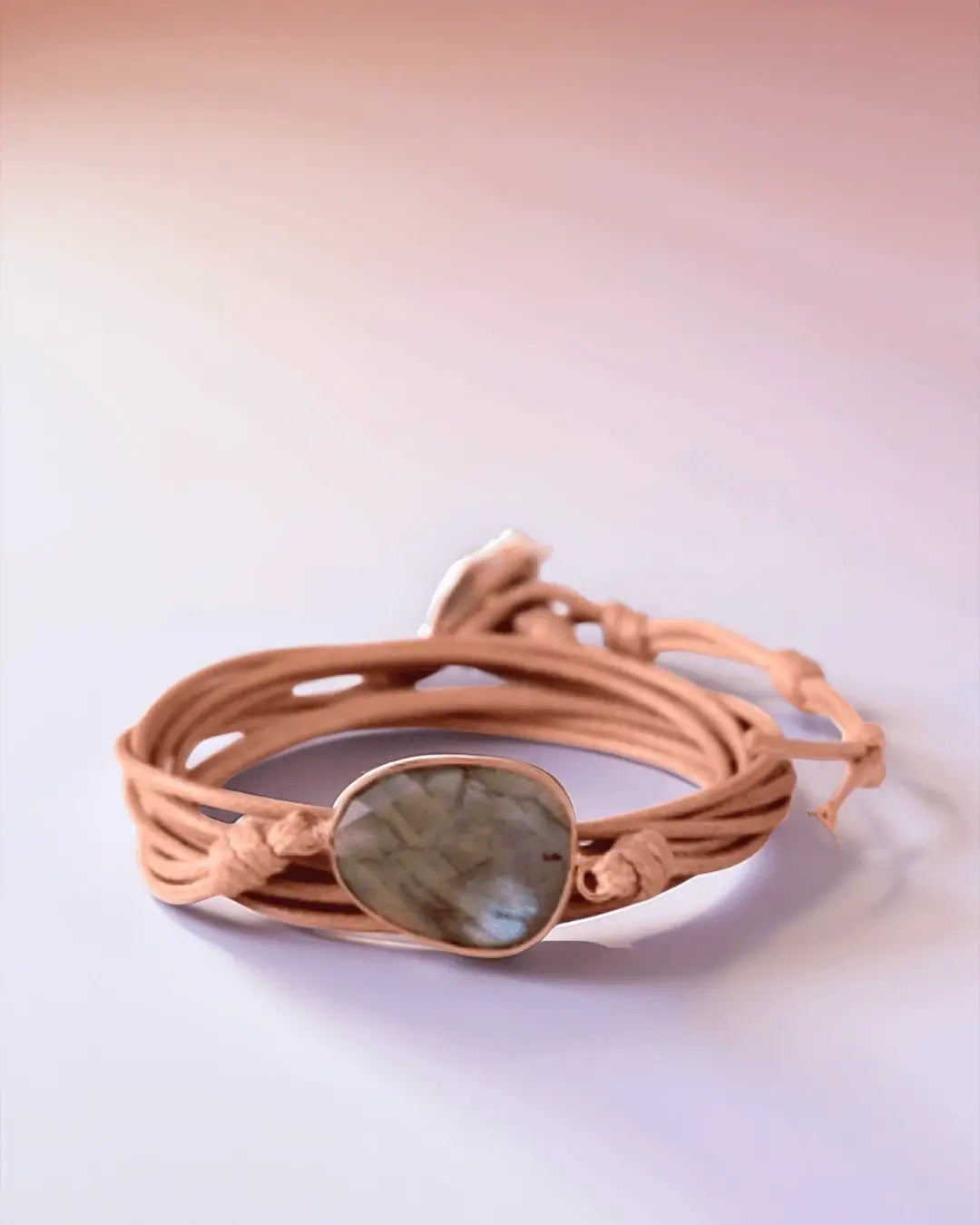 Bohemian style multi-wrap bracelet with a light brown suede strap and a bezel-set, polished Labradorite gemstone centerpiece.