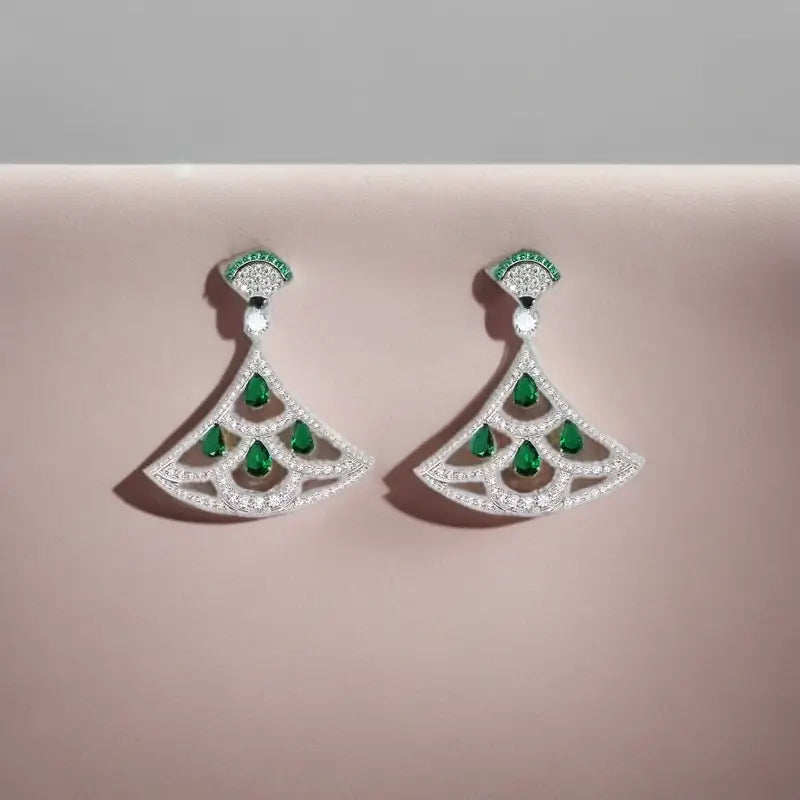 Pair of Art Deco fan-design dangle earrings in white gold and diamond pave, featuring six large pear-cut emerald gemstones.