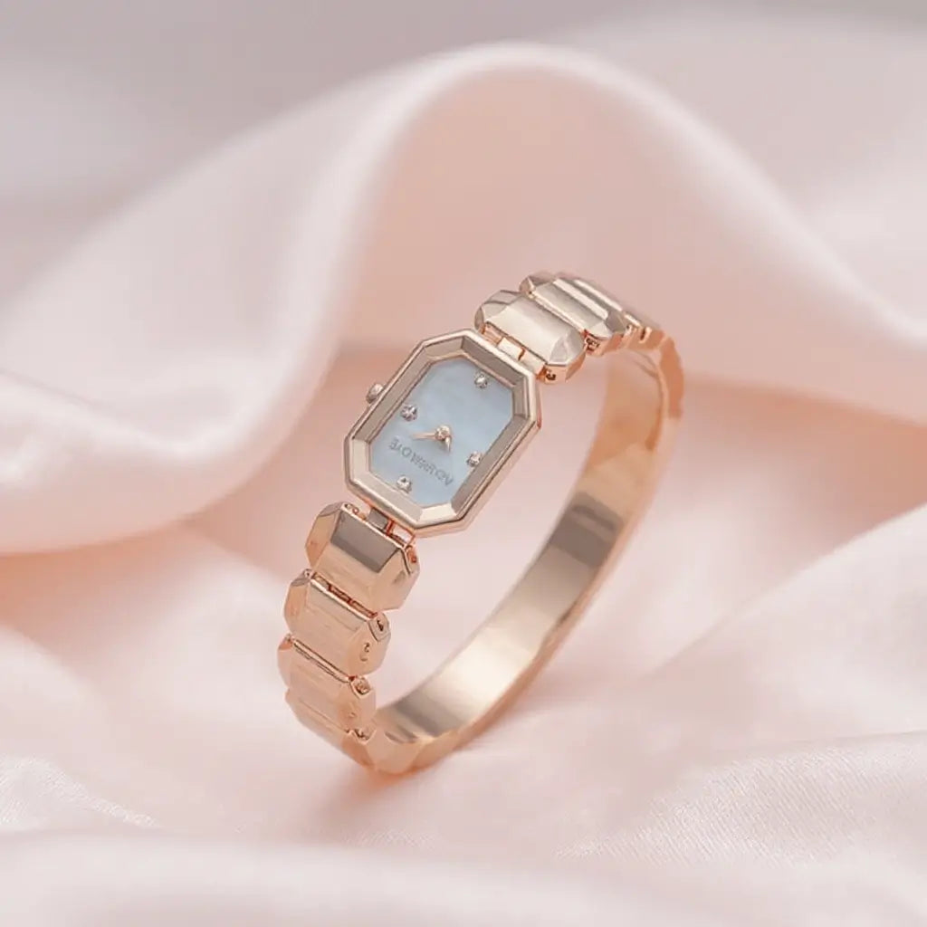 Rose gold bangle watch with a mother-of-pearl dial and a unique octagonal, art deco-style case and link bracelet.
