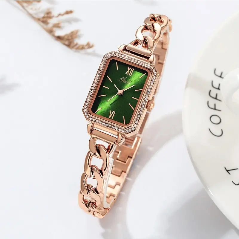 Rose gold chain link bracelet watch with a rhinestone rectangular bezel and a striking emerald green dial, ideal for women.